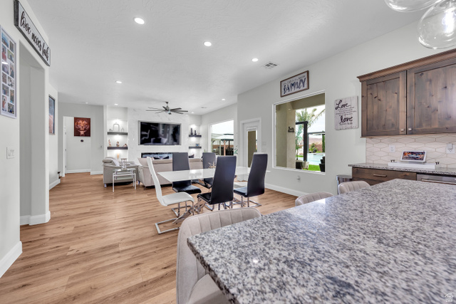 6105 Bunda Way St. George, UT 84790 - Photo 11 of 49 Open-concept living space featuring wood-finish flooring, recessed lighting, and a contemporary ceiling fan
