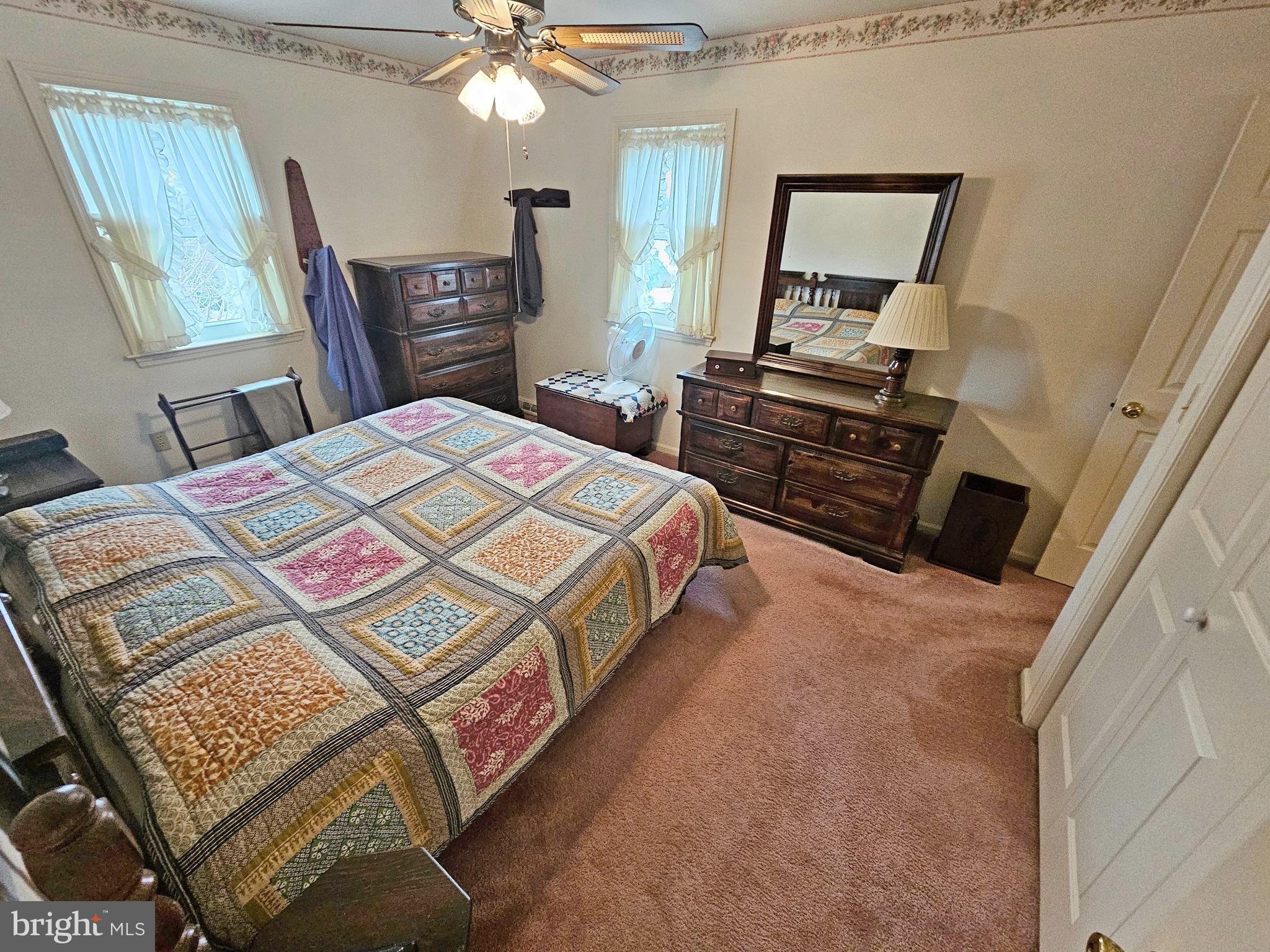 402 Snyder Hill Road Lititz, PA 17543 - Photo 24 of 35 a bedroom with a bed and dresser with mirror
