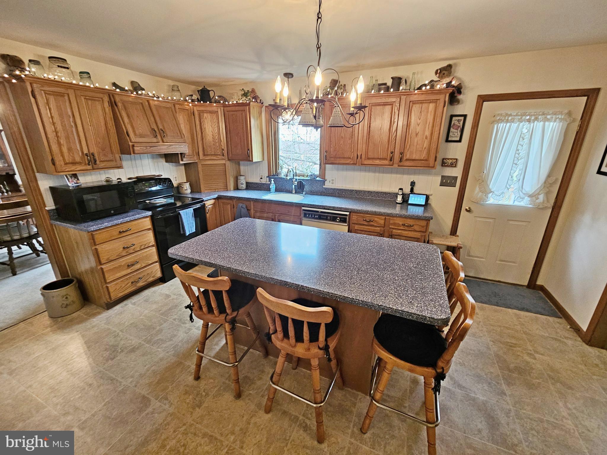 402 Snyder Hill Road Lititz, PA 17543 - Photo 5 of 35 a kitchen with a table chairs and a refrigerator