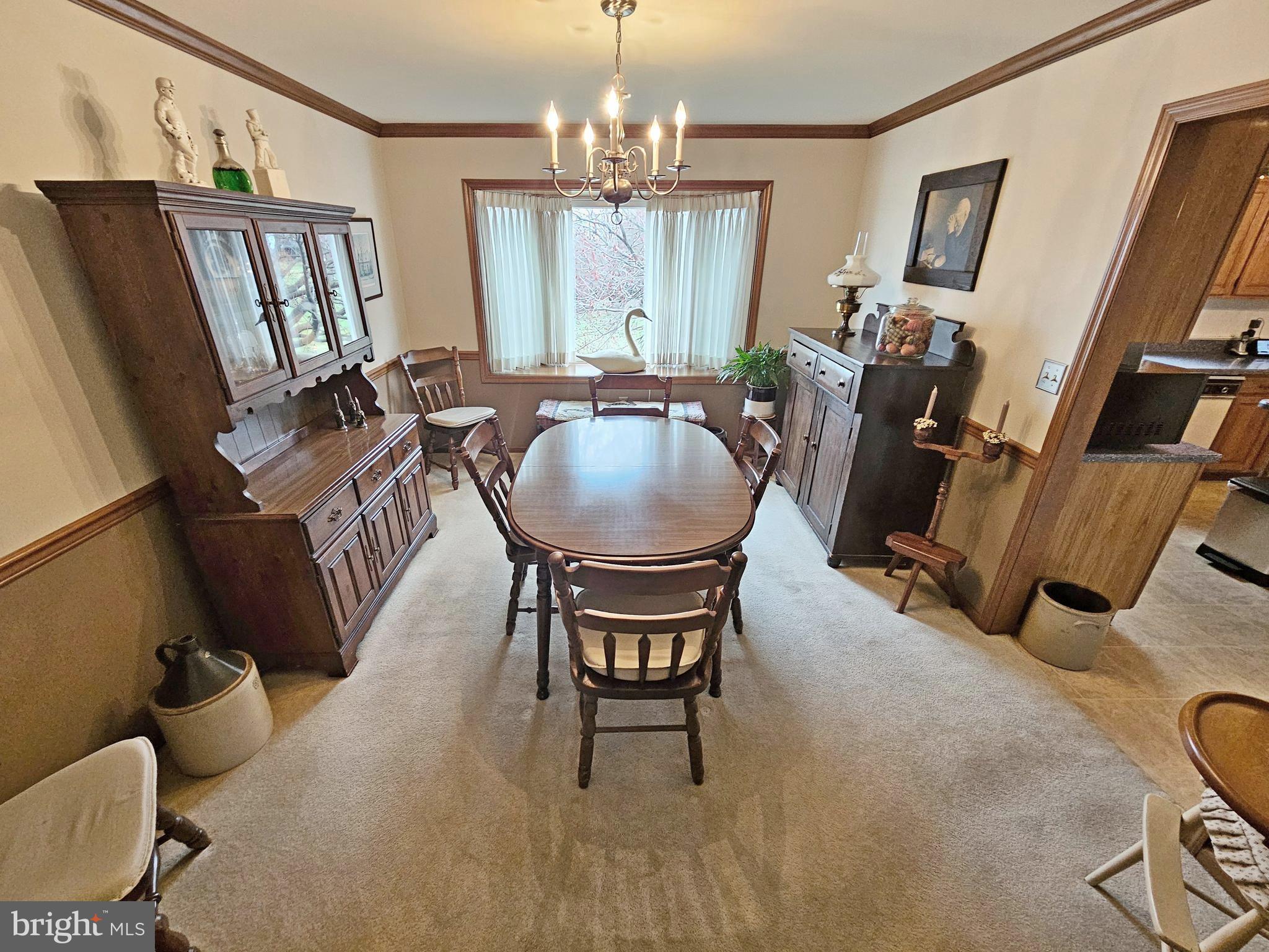 402 Snyder Hill Road Lititz, PA 17543 - Photo 6 of 35 a dining room with furniture a chandelier and wooden floor