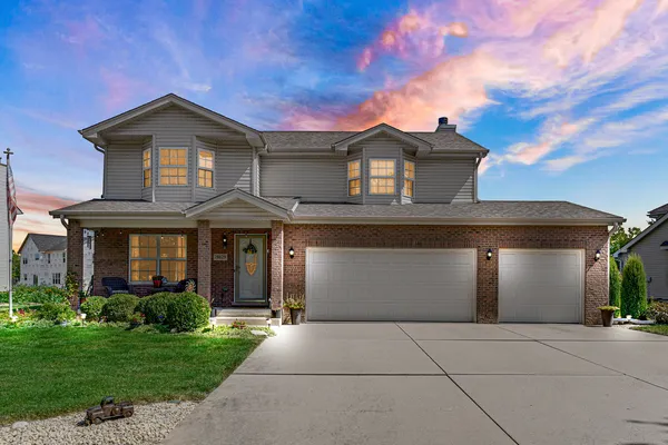 a front view of a house with a yard and garage