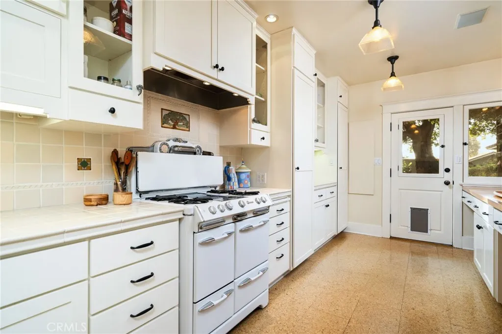335 Harvard Avenue North Claremont, CA 91711 - Photo 12 of 71 a kitchen with a stove a sink and a refrigerator