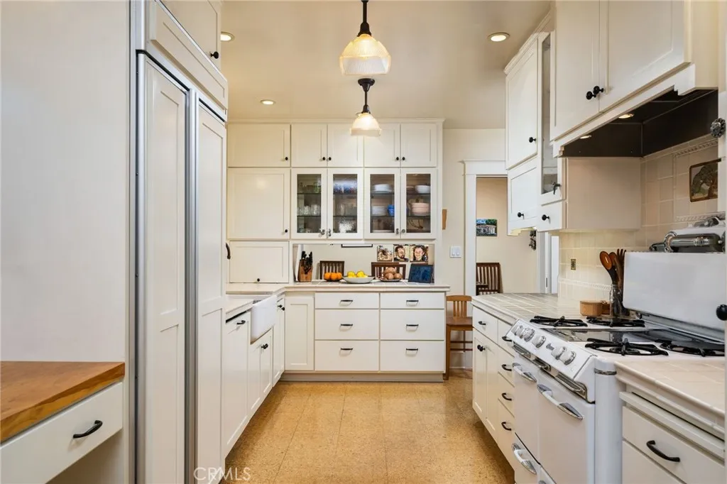 335 Harvard Avenue North Claremont, CA 91711 - Photo 13 of 71 a kitchen with stainless steel appliances a stove a sink cabinets and a refrigerator
