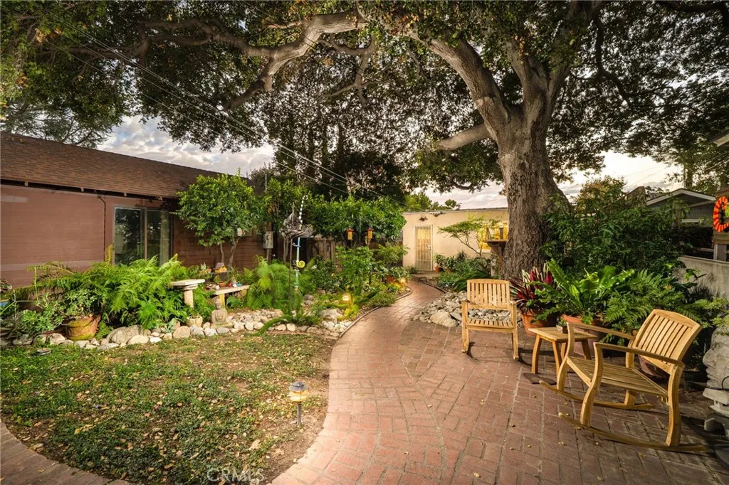 335 Harvard Avenue North Claremont, CA 91711 - Photo 32 of 71 a view of a patio with table and chairs and potted plants with large tree