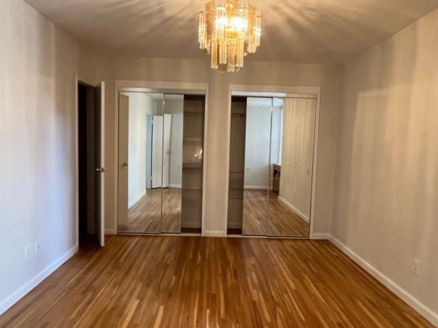 200 Corbin Place, Unit 2H Brooklyn, NY 11235 - Photo 5 of 18 wooden floor in an empty room with a window