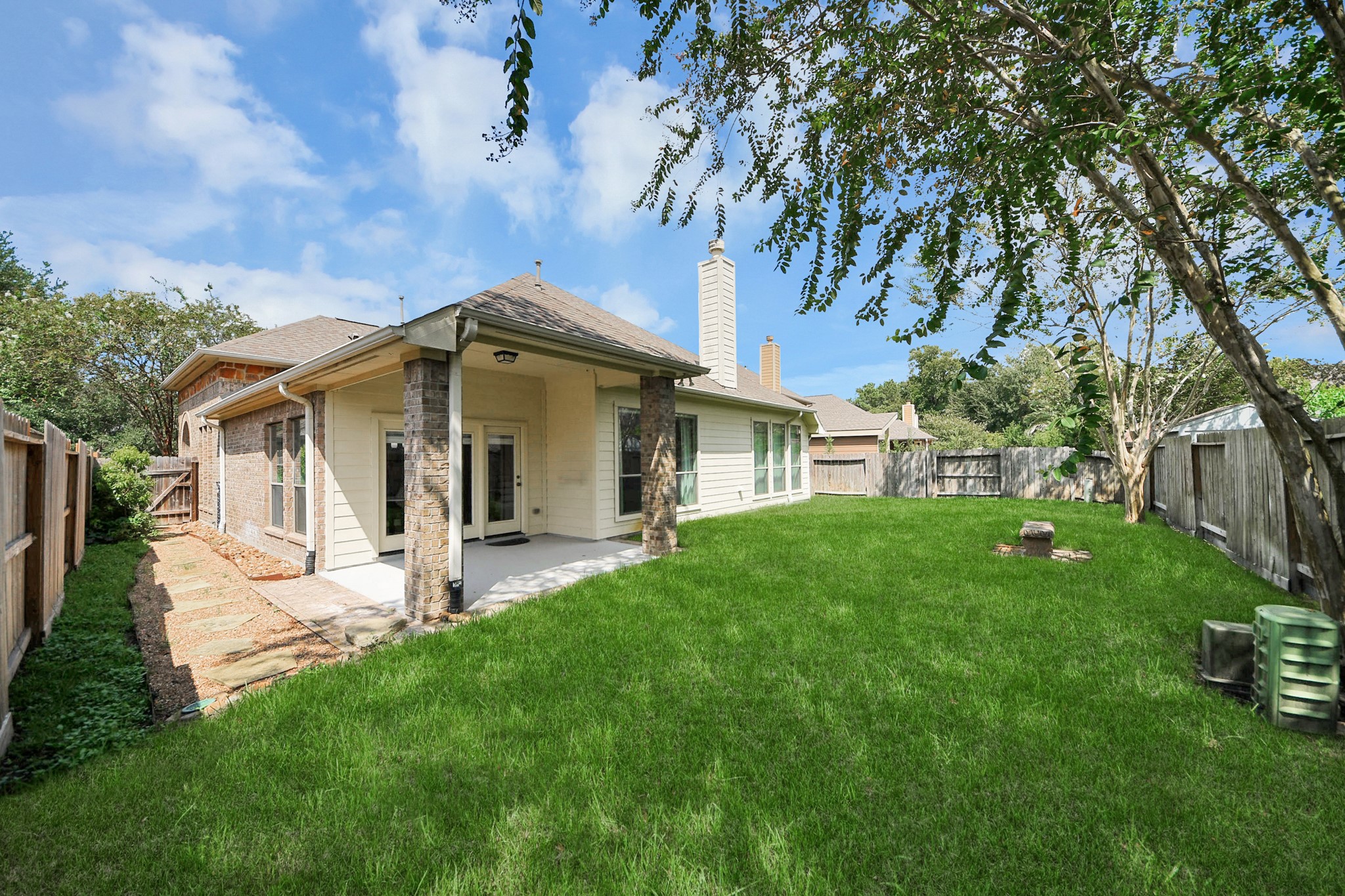 27515 Chris Ridge Court Spring, TX 77386 - Photo 11 of 48 Stone side walkway, ready for your garden dreams! Lush backyard with mature trees and covered porch to enjoy the outdoors.