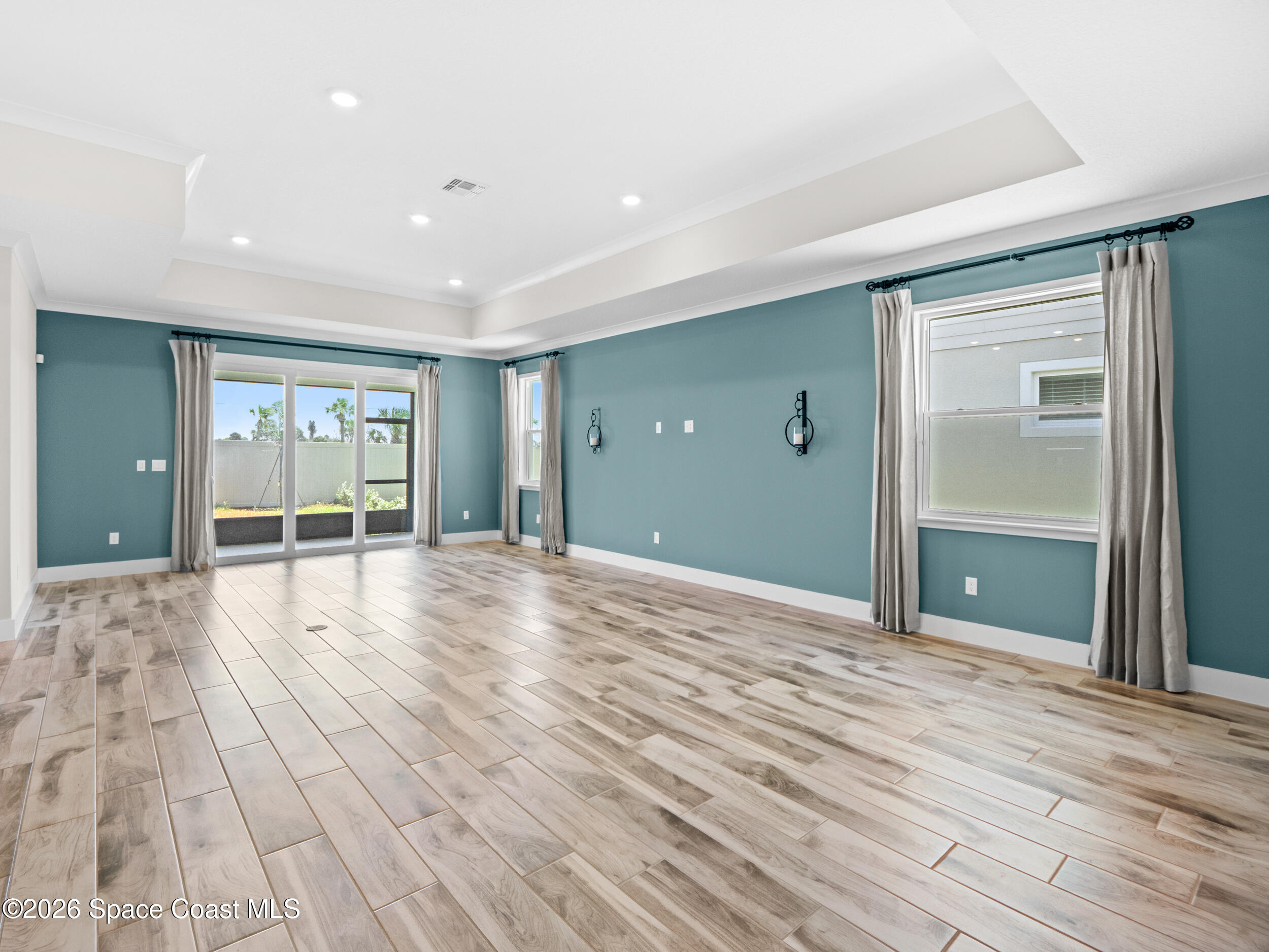 27 Gulfstream Way Satellite Beach, FL 32937 - Photo 12 of 26 a view of an empty room with wooden floor and a window