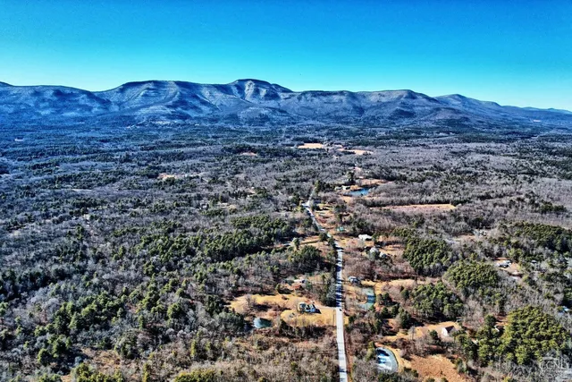 a kitchen with stainless steel appliances granite countertop a stove a sink dishwasher a dining table and chairs with wooden floor