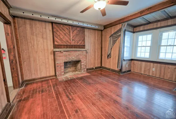 a bed room with a bed window and a flat screen tv