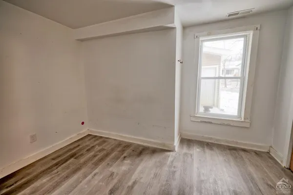 a kitchen with wooden floors and appliances