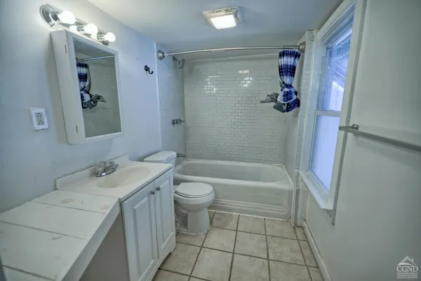 a kitchen with a refrigerator and a stove top oven