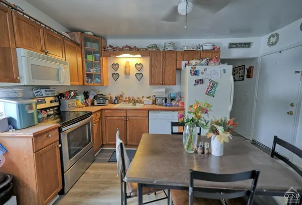 a kitchen with stainless steel appliances a stove a sink cabinets and a dining table