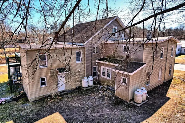a view of a room that has wooden floor and bench in it