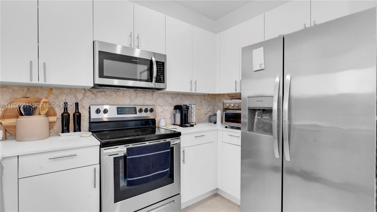 11922 Southwest 245 Terrace Homestead, FL 33032 - Photo 11 of 31 a kitchen with cabinets stainless steel appliances and a counter space