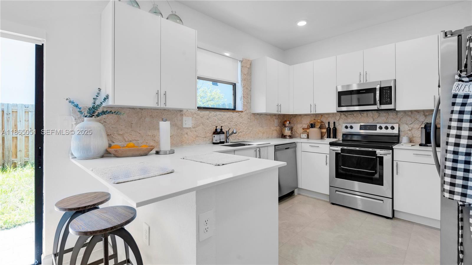 11922 Southwest 245 Terrace Homestead, FL 33032 - Photo 12 of 31 a kitchen that has a sink and a stove in it