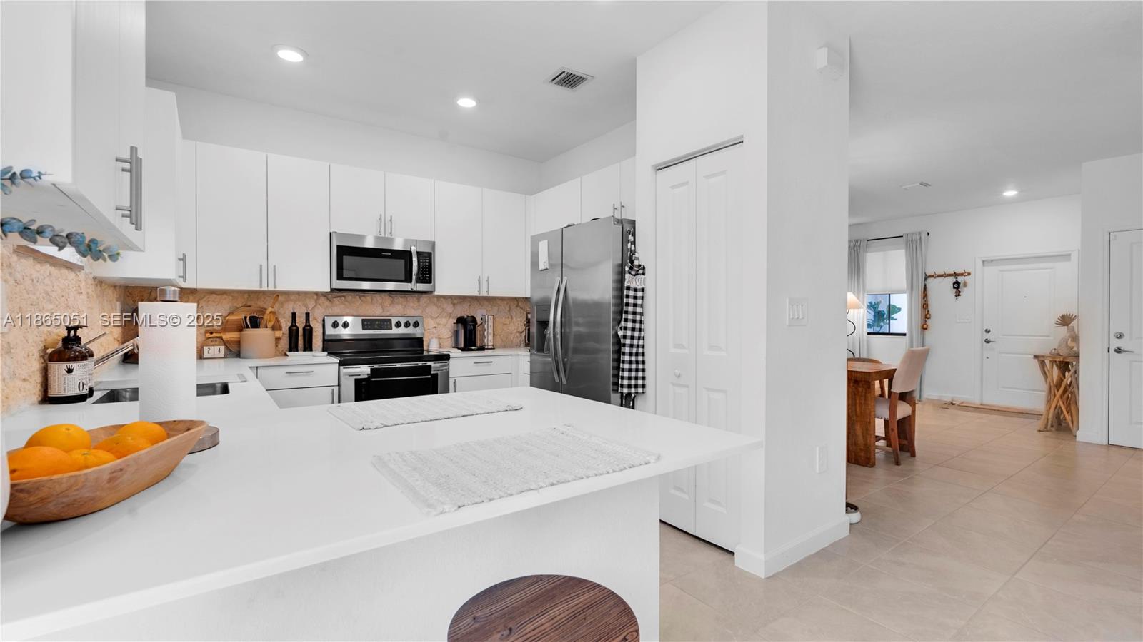 11922 Southwest 245 Terrace Homestead, FL 33032 - Photo 13 of 31 a kitchen with stainless steel appliances a refrigerator sink microwave and cabinets