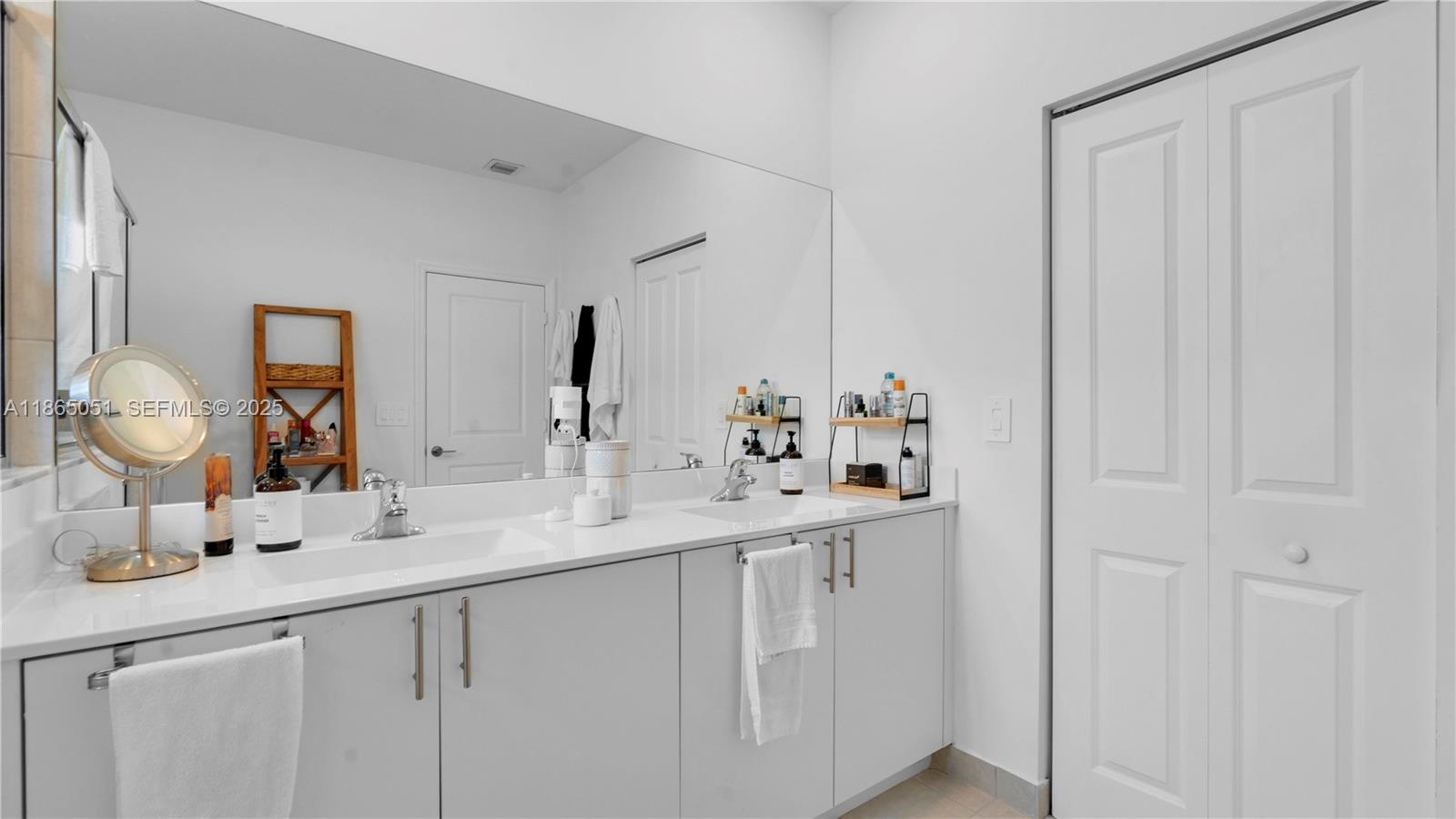 11922 Southwest 245 Terrace Homestead, FL 33032 - Photo 17 of 31 a bathroom with a double vanity sink and a mirror