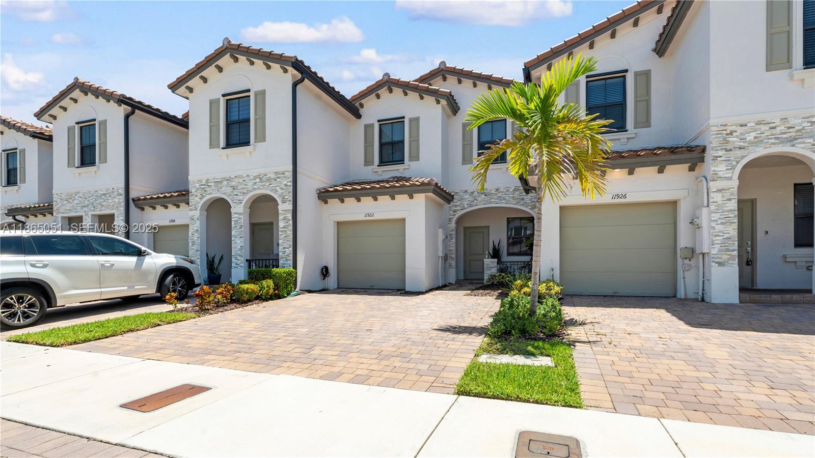 11922 Southwest 245 Terrace Homestead, FL 33032 - Photo 2 of 31 a front view of a house with a yard and garage