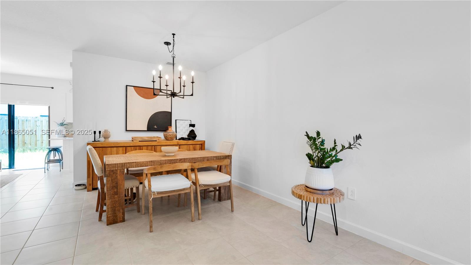 11922 Southwest 245 Terrace Homestead, FL 33032 - Photo 6 of 31 a dining room with furniture a rug and a chandelier