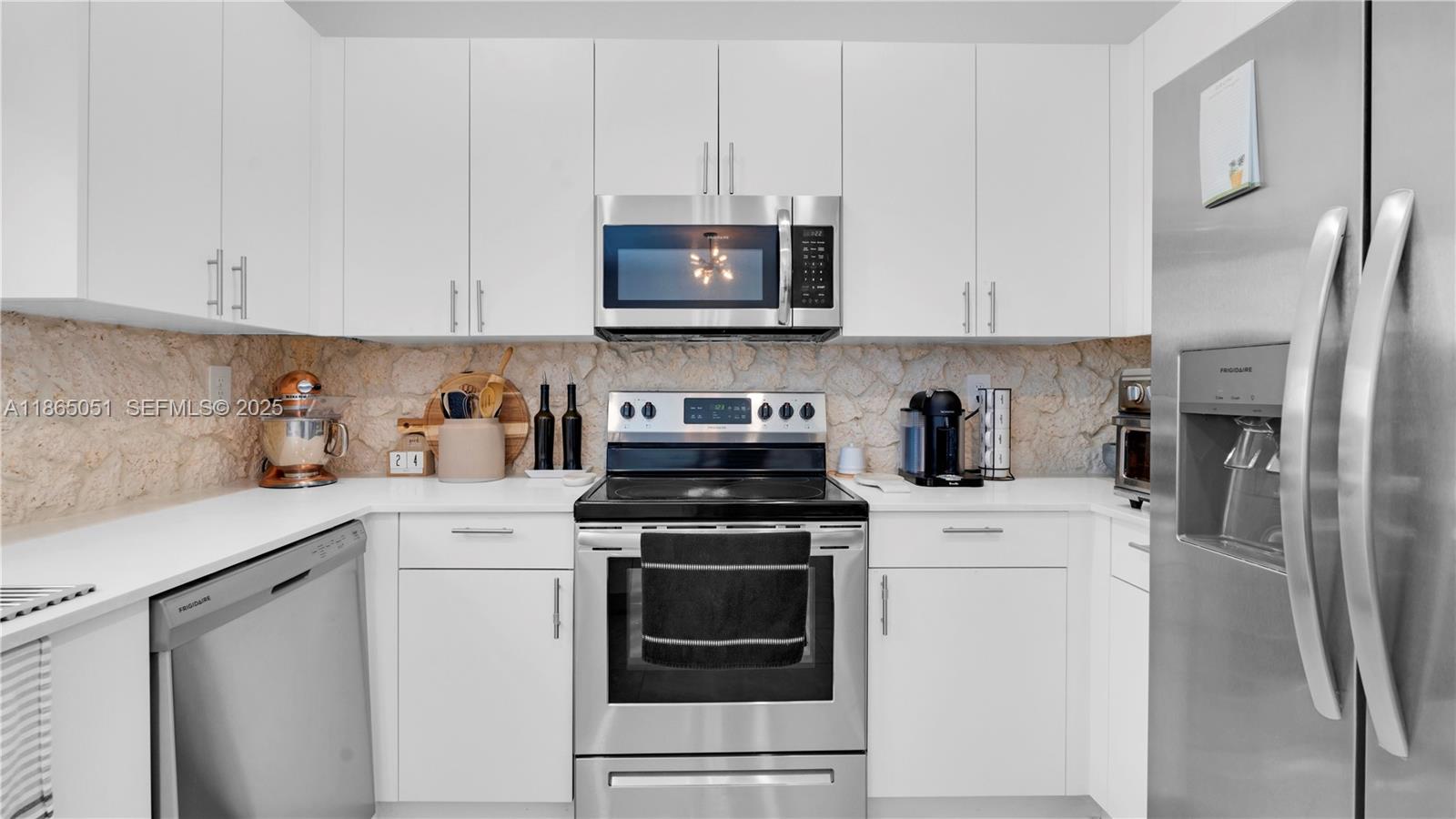 11922 Southwest 245 Terrace Homestead, FL 33032 - Photo 9 of 31 a kitchen with stainless steel appliances granite countertop white cabinets sink and a refrigerator