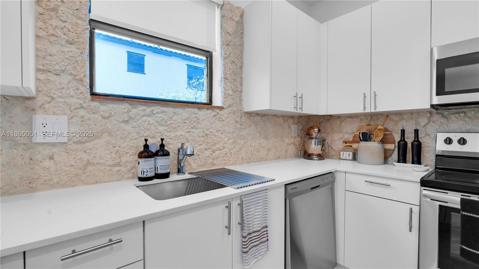 11922 Southwest 245 Terrace Homestead, FL 33032 - Photo 10 of 31 a kitchen with stainless steel appliances white cabinets sink and a stove