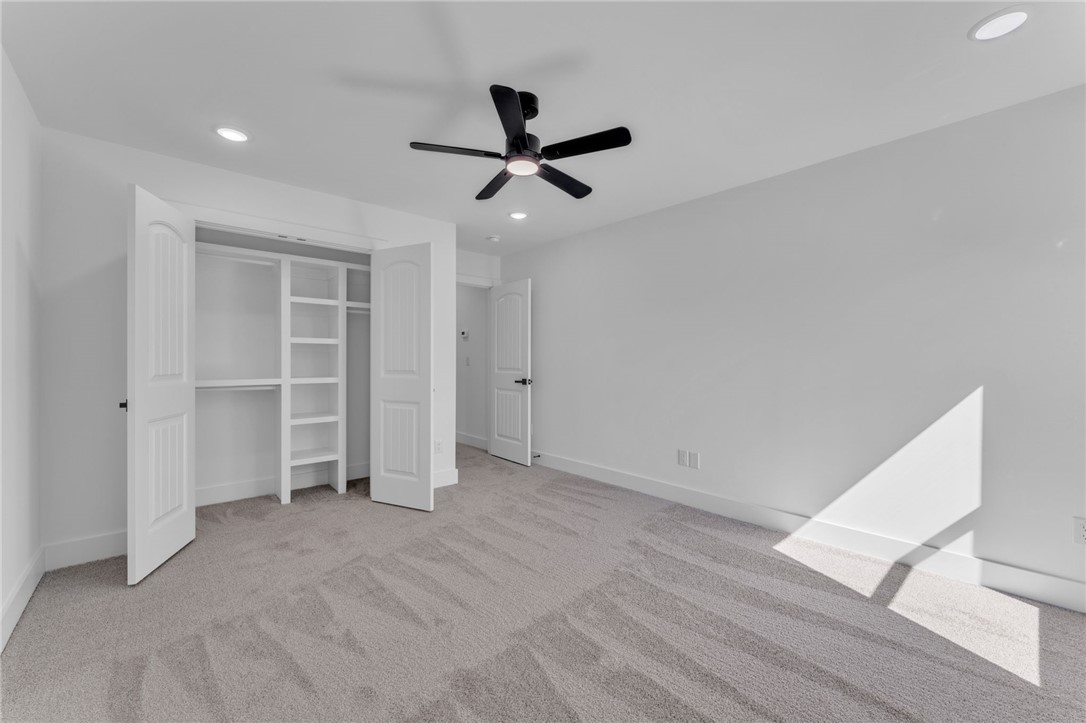 1723 Harris Bridge Road Anderson, SC 29621 - Photo 22 of 33 A well-lit bedroom features plush carpeting and a built-in closet system, offering comfort and organization.