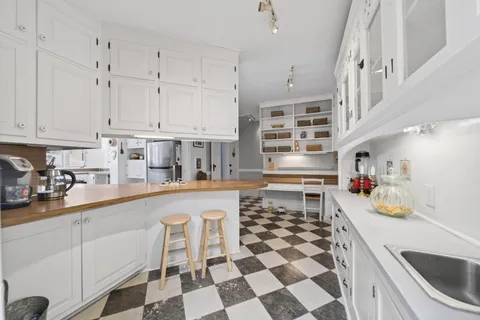 a kitchen with a sink a stove and cabinets