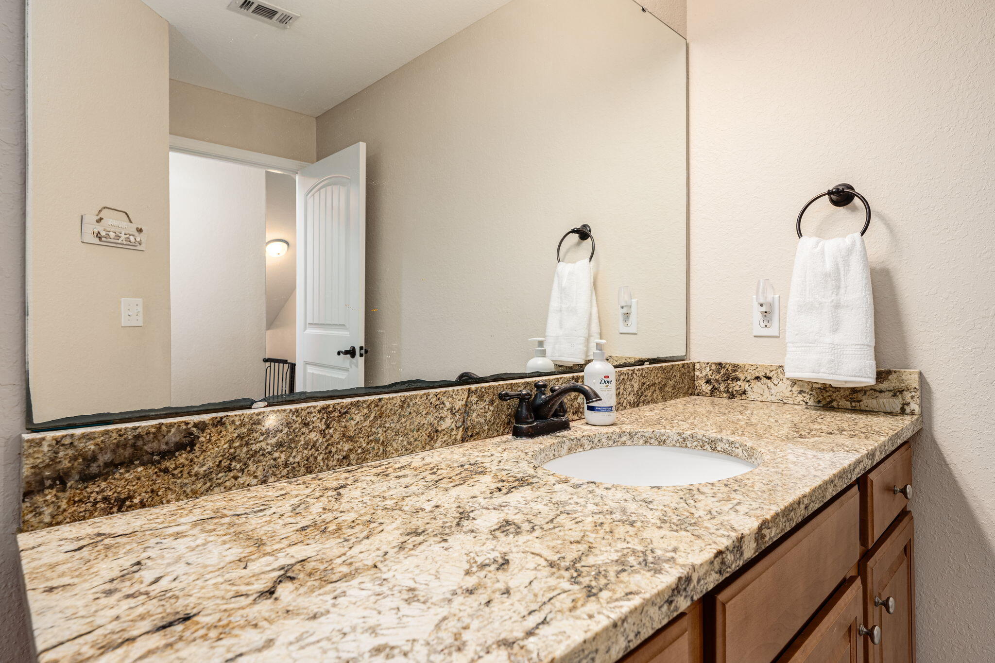 4591 Hermosa Road Crestview, FL 32539 - Photo 50 of 59 a bathroom with a granite countertop sink and a mirror