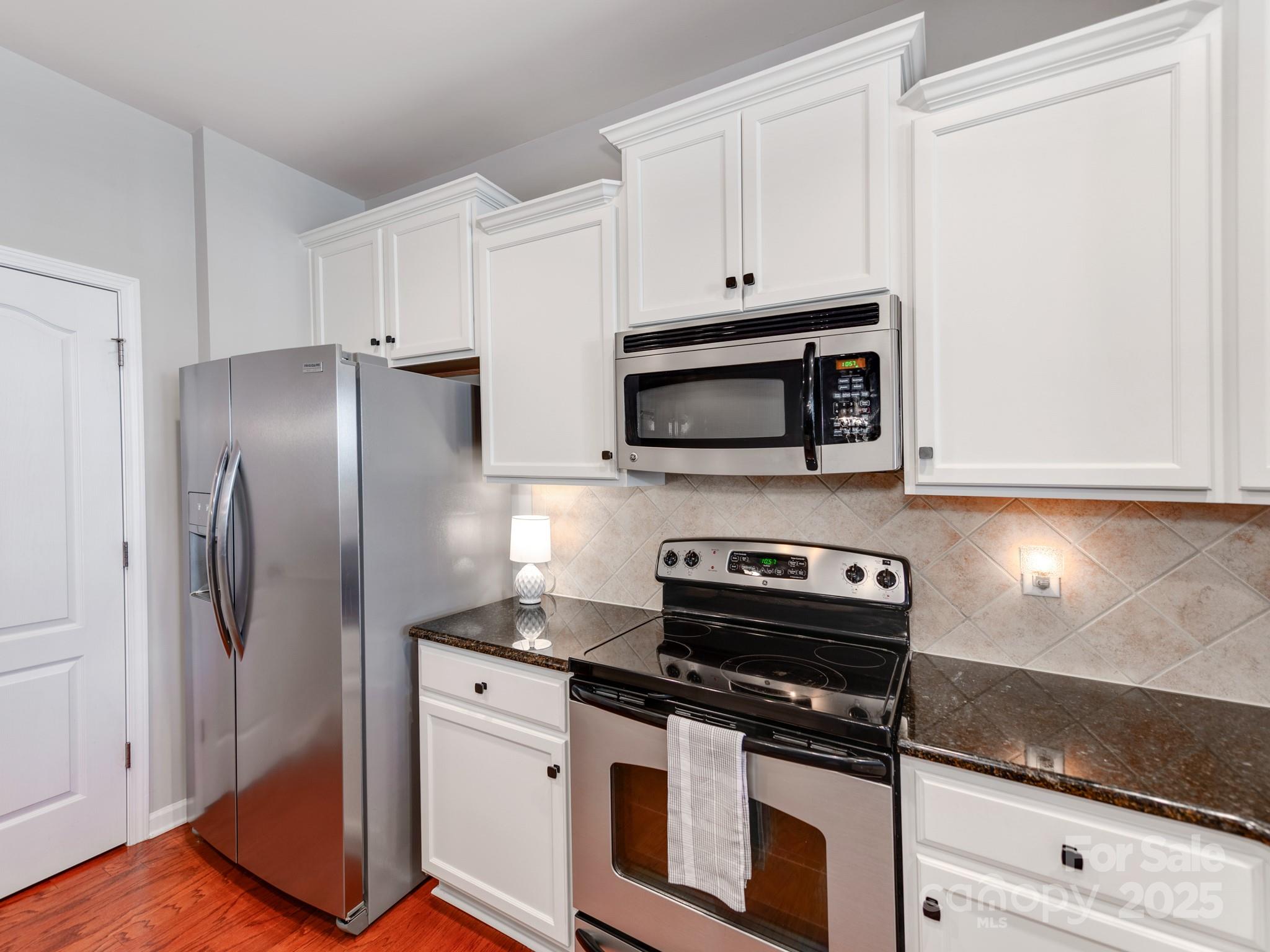 8244 Viewpoint Lane Cornelius, NC 28031 - Photo 13 of 33 a kitchen with cabinets and steel stainless steel appliances