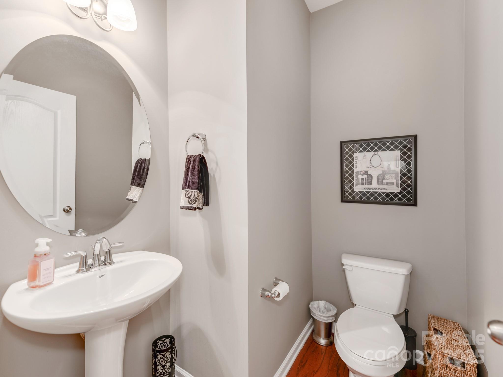 8244 Viewpoint Lane Cornelius, NC 28031 - Photo 16 of 33 a bathroom with a toilet a sink and mirror