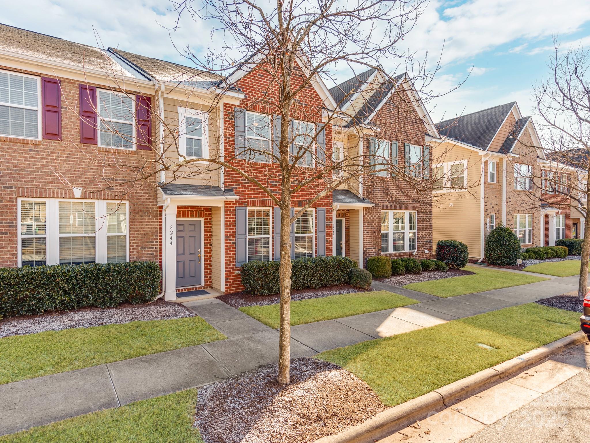 8244 Viewpoint Lane Cornelius, NC 28031 - Photo 2 of 33 a view of a brick house with a yard in front of it