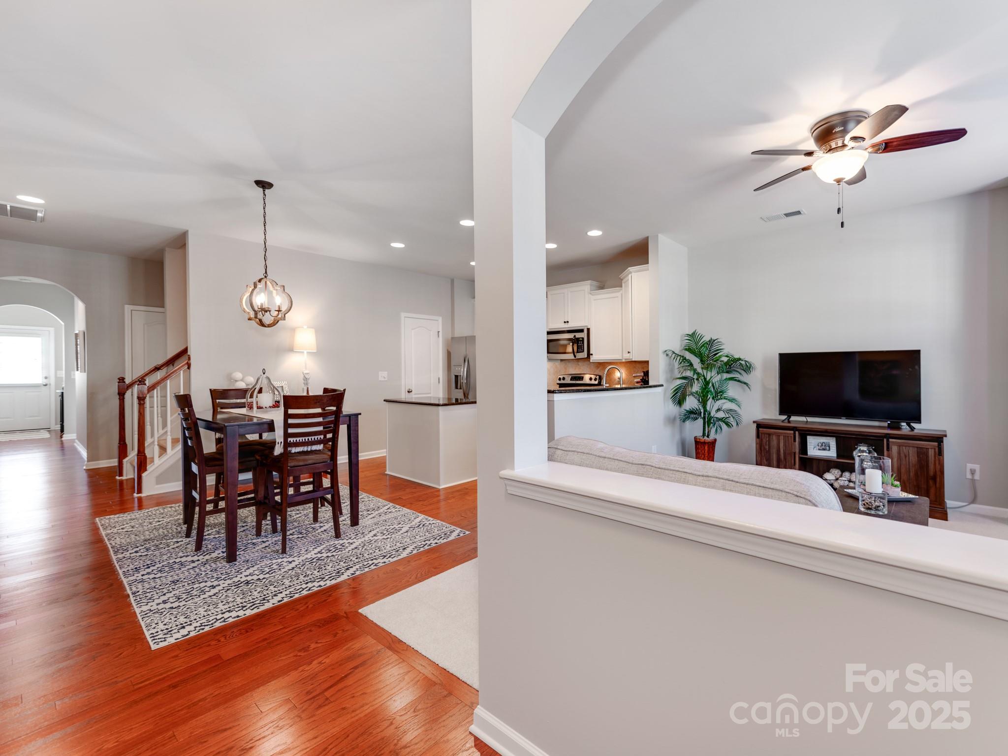 8244 Viewpoint Lane Cornelius, NC 28031 - Photo 4 of 33 a view of a dining room with furniture and wooden floor