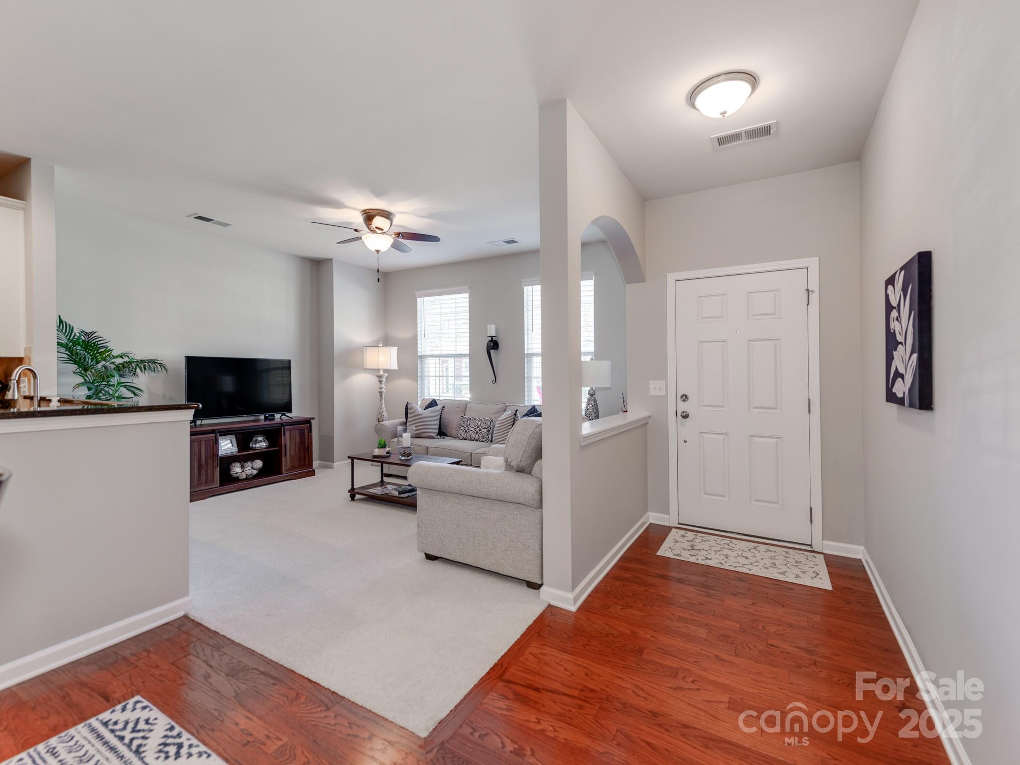 8244 Viewpoint Lane Cornelius, NC 28031 - Photo 5 of 33 a living room with furniture a flat screen tv and a fireplace