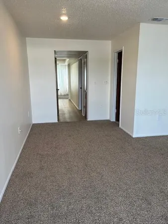 a view of an empty room and closet area