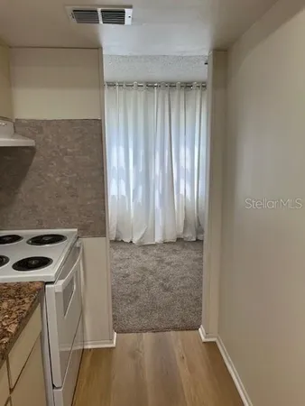 an entryway with wooden floor