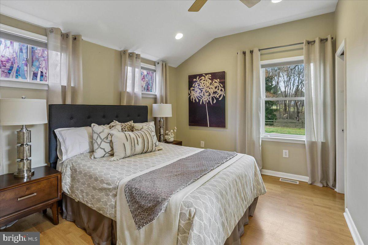 22325 Nicholson Farm Road Dickerson, MD 20842 - Photo 6 of 32 a bedroom with a bed and a painting on the wall