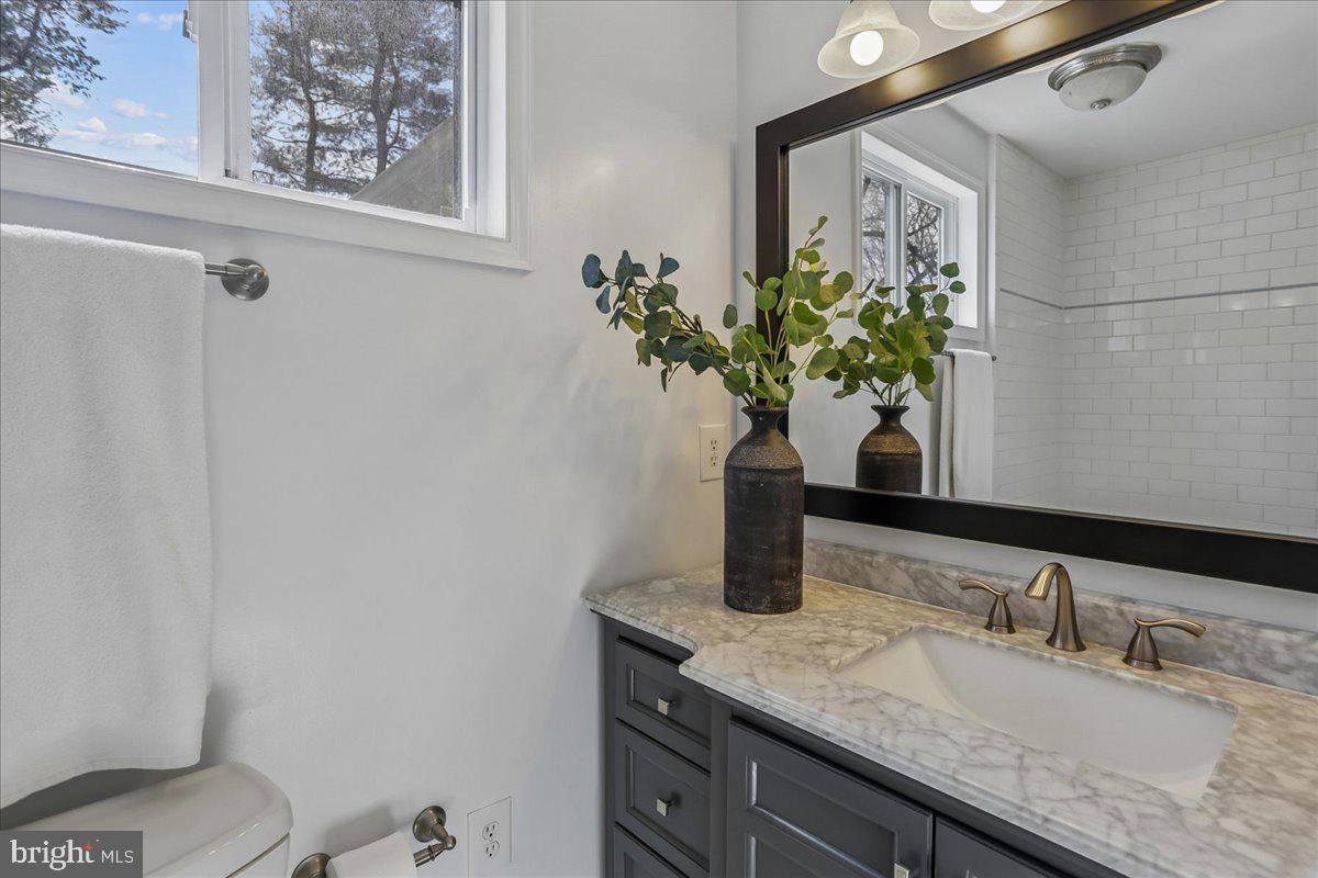 22325 Nicholson Farm Road Dickerson, MD 20842 - Photo 8 of 32 a bathroom with a granite countertop sink a toilet and mirror
