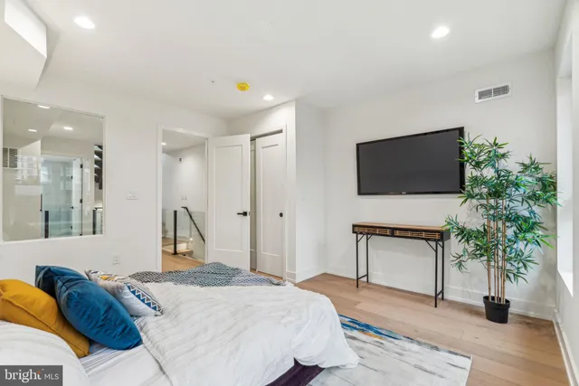 a view of a hallway with a livingroom and a bathroom with sink