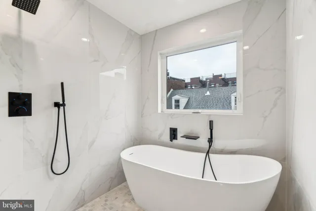 a view of a hallway with wooden floor and entryway