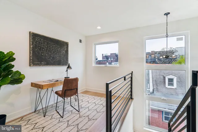 a view of a livingroom with furniture and a potted plant