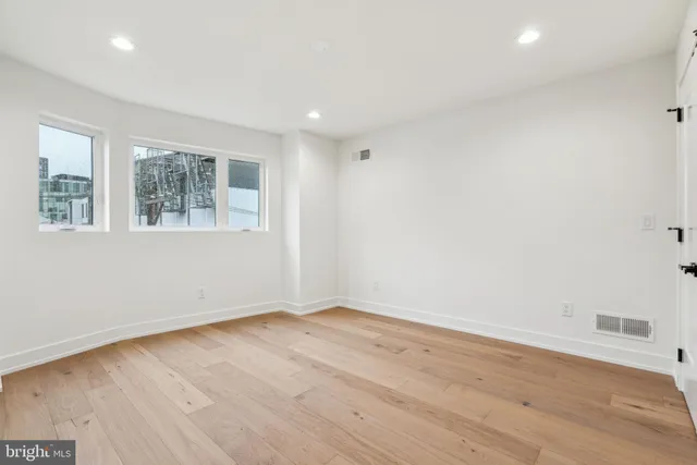 a front view of a building with lot of cars