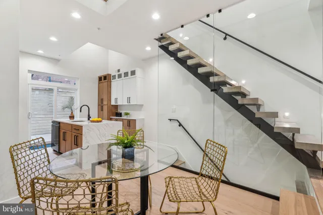a dining room with furniture and wooden floor