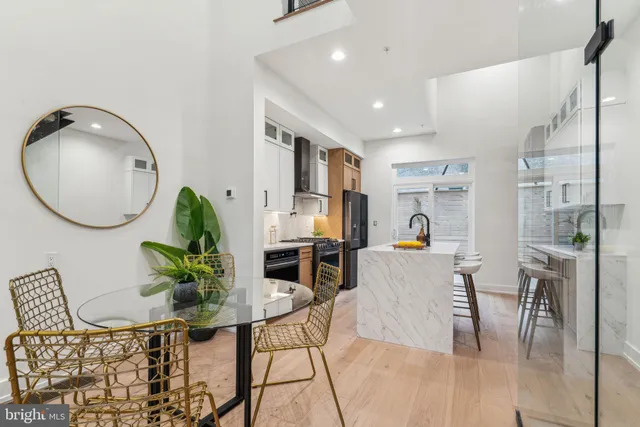 a kitchen with stainless steel appliances a sink stove and refrigerator