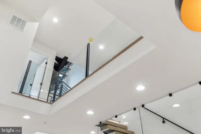 a kitchen with stainless steel appliances kitchen island granite countertop a stove a sink and a refrigerator