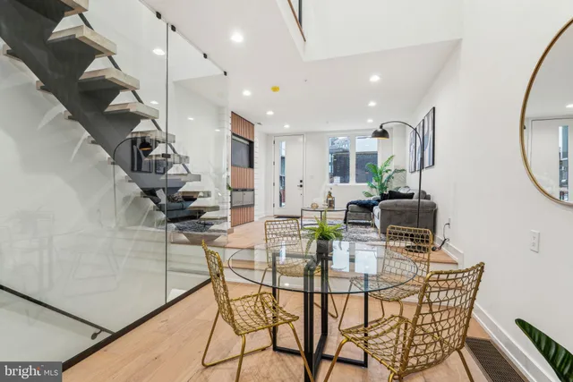 a kitchen with a table chairs and a dining table