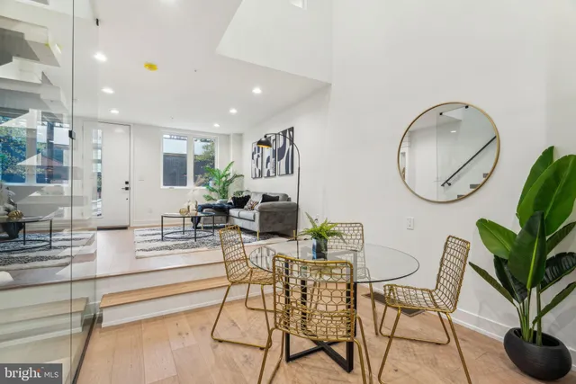 a kitchen with stainless steel appliances granite countertop a sink a stove and a wooden floors