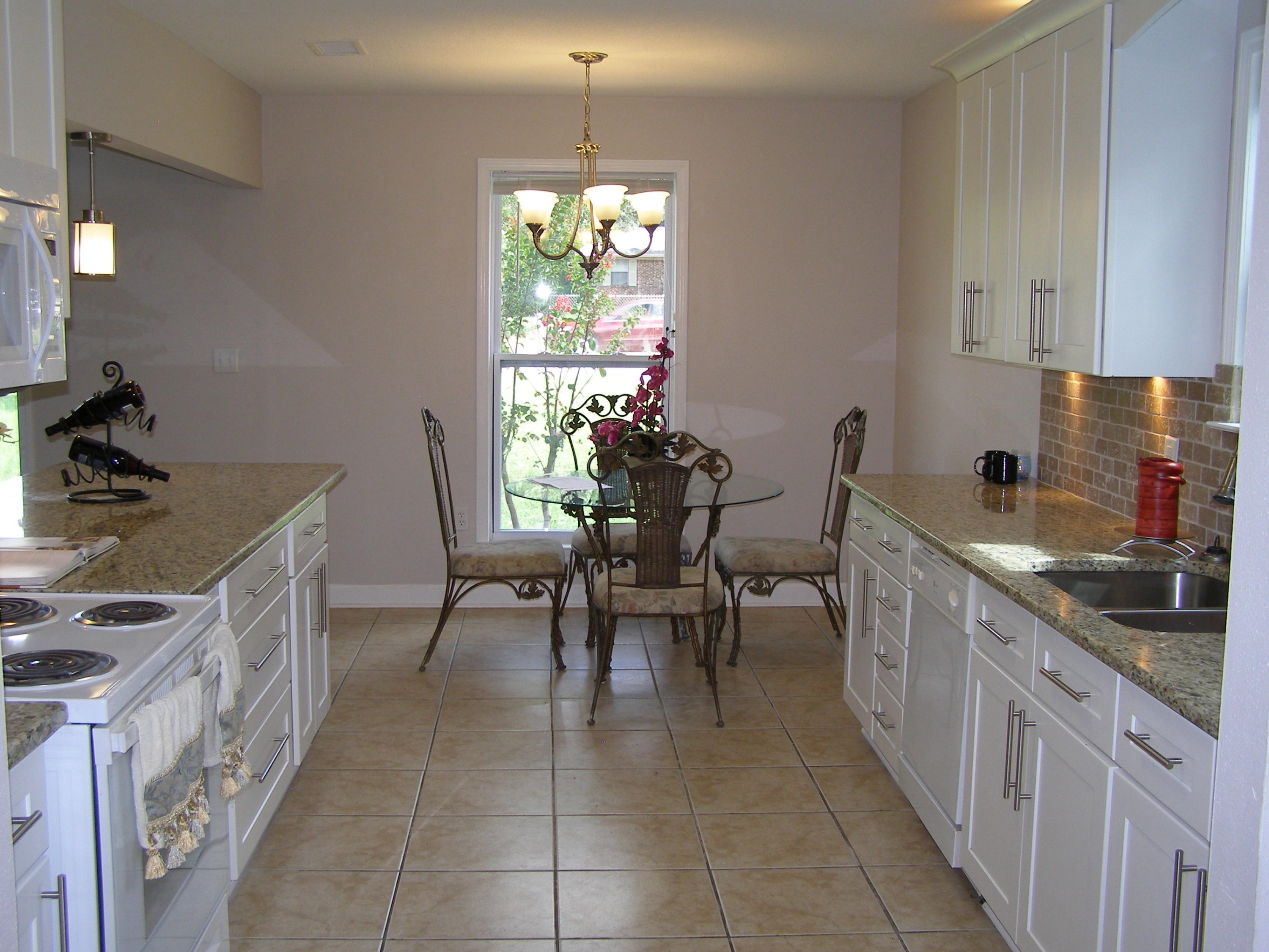 3356 Auburn Road Crestview, FL 32539 - Photo 11 of 34 a kitchen with furniture a window and appliances