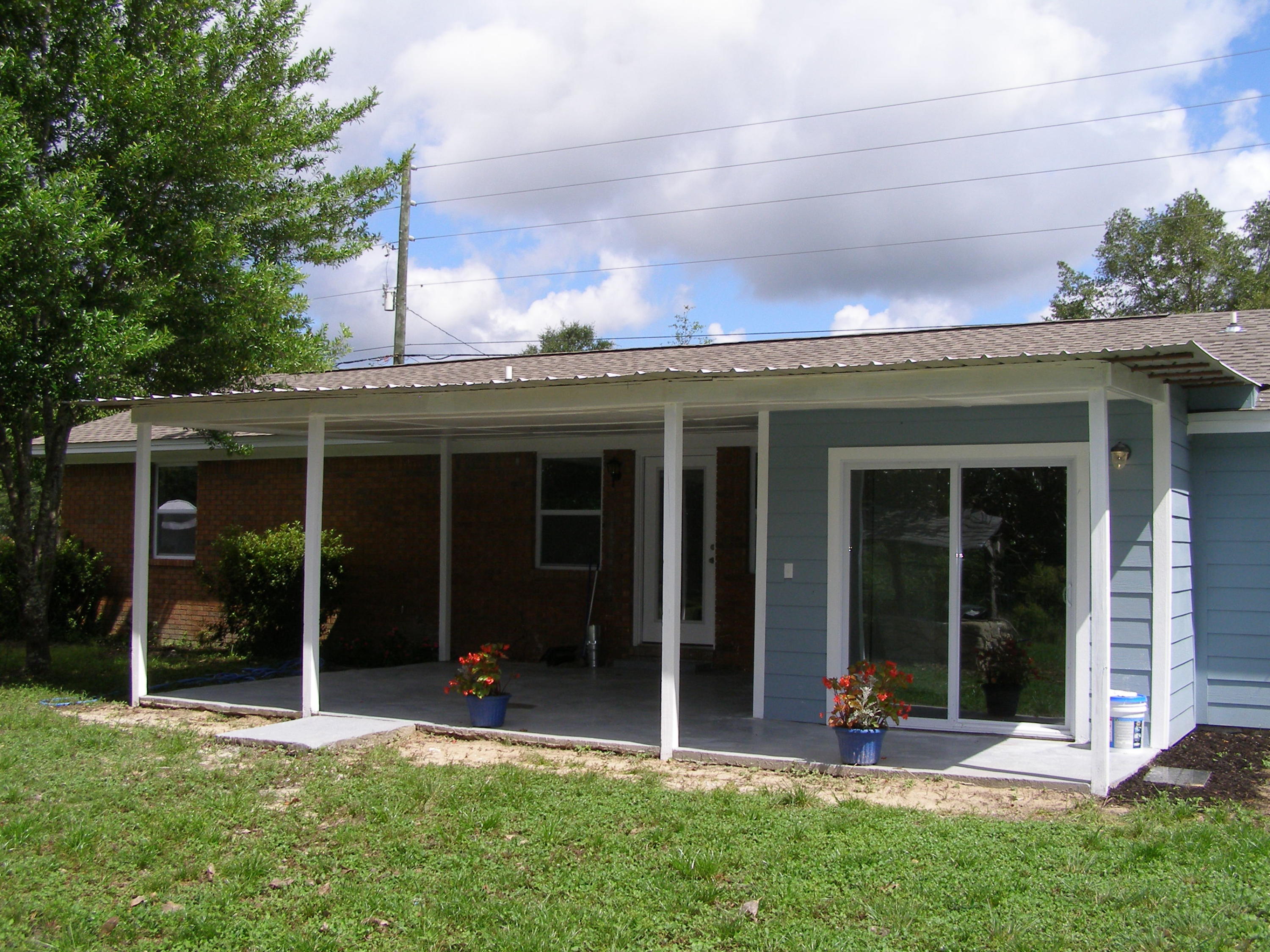 3356 Auburn Road Crestview, FL 32539 - Photo 29 of 34 front view of a house with a yard glass top table and chairs