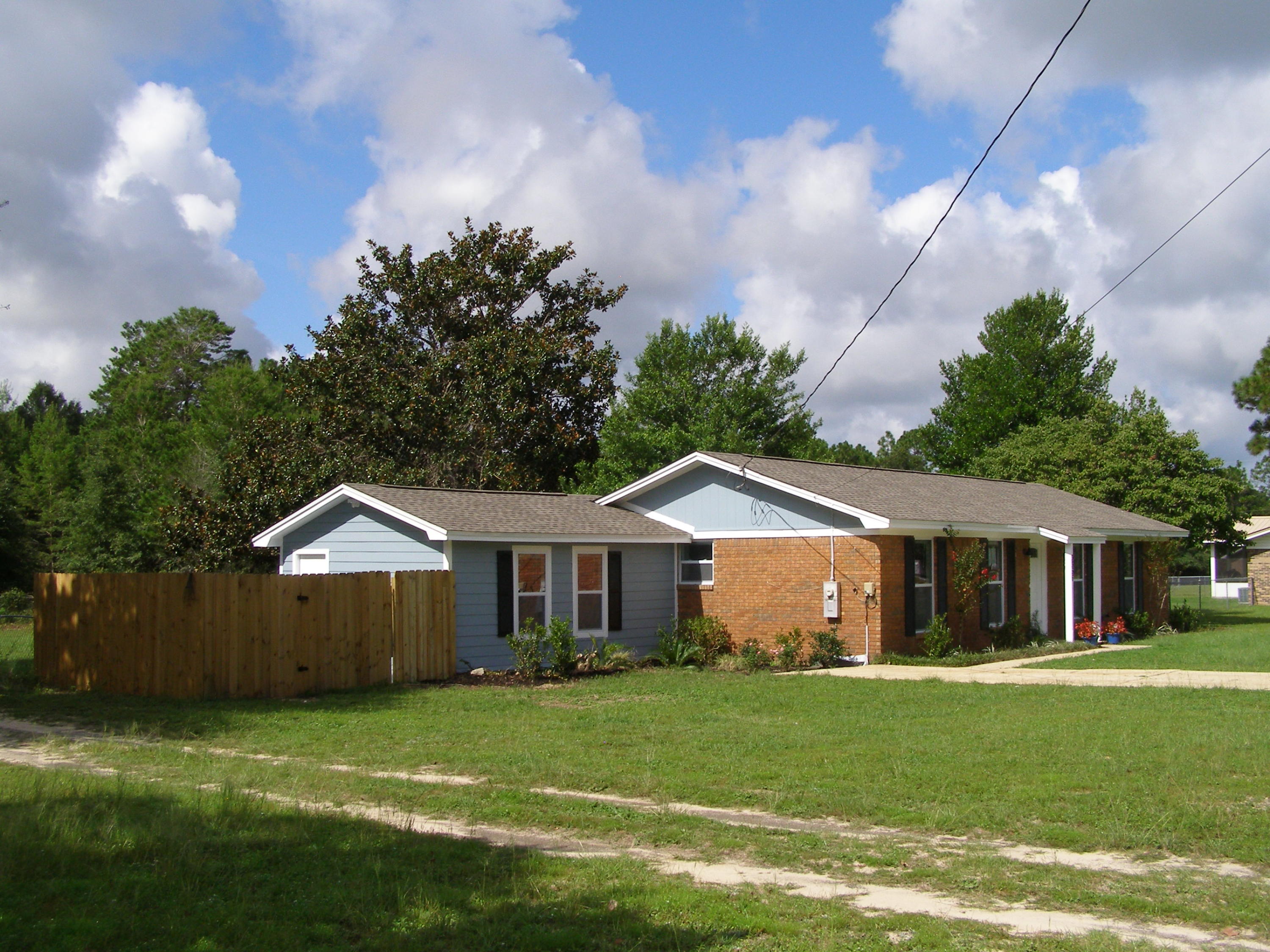 3356 Auburn Road Crestview, FL 32539 - Photo 3 of 34 a front view of a house with a yard and garage