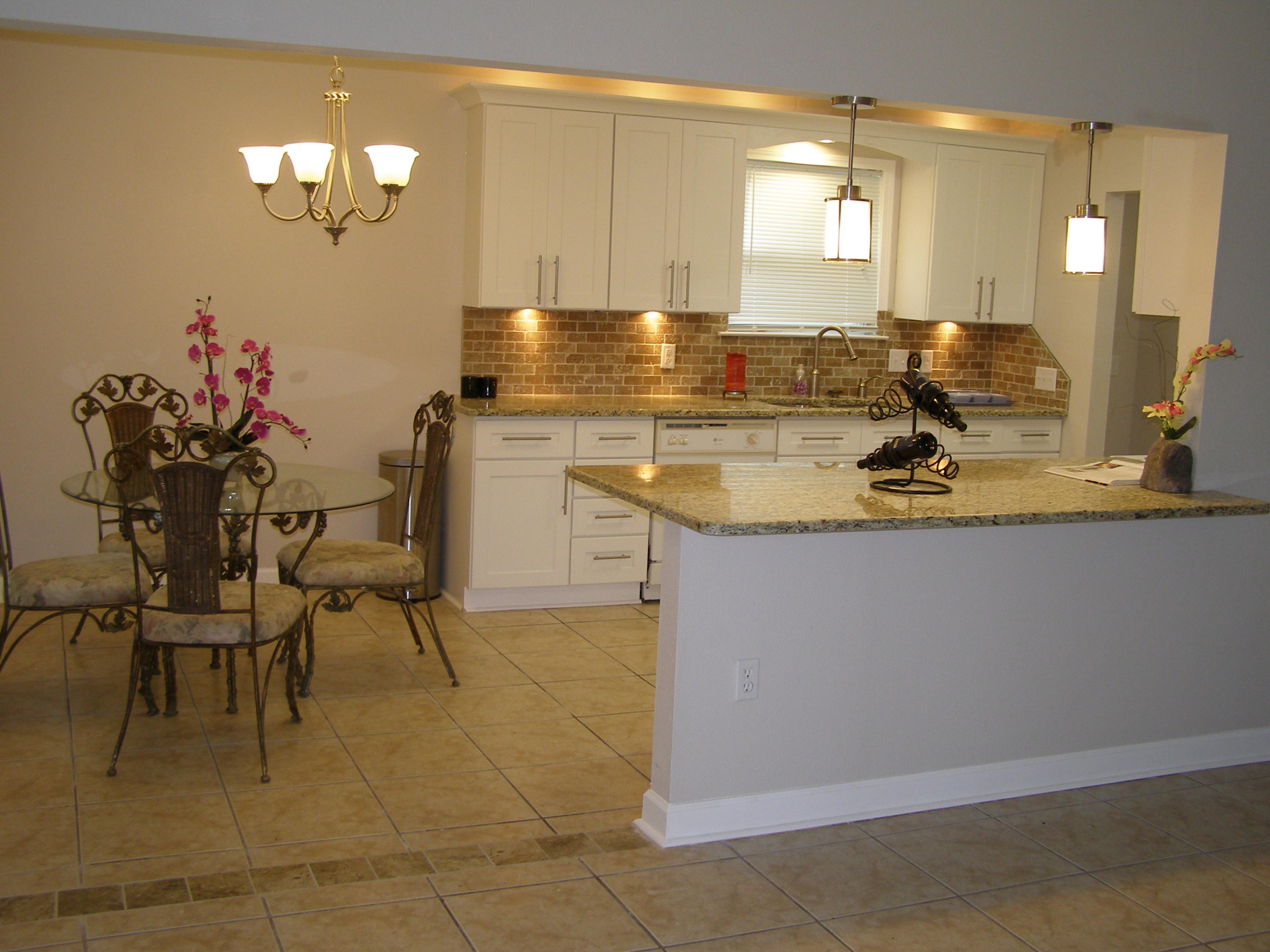 3356 Auburn Road Crestview, FL 32539 - Photo 7 of 34 a view of a kitchen with granite countertop a counter space chairs and cabinets